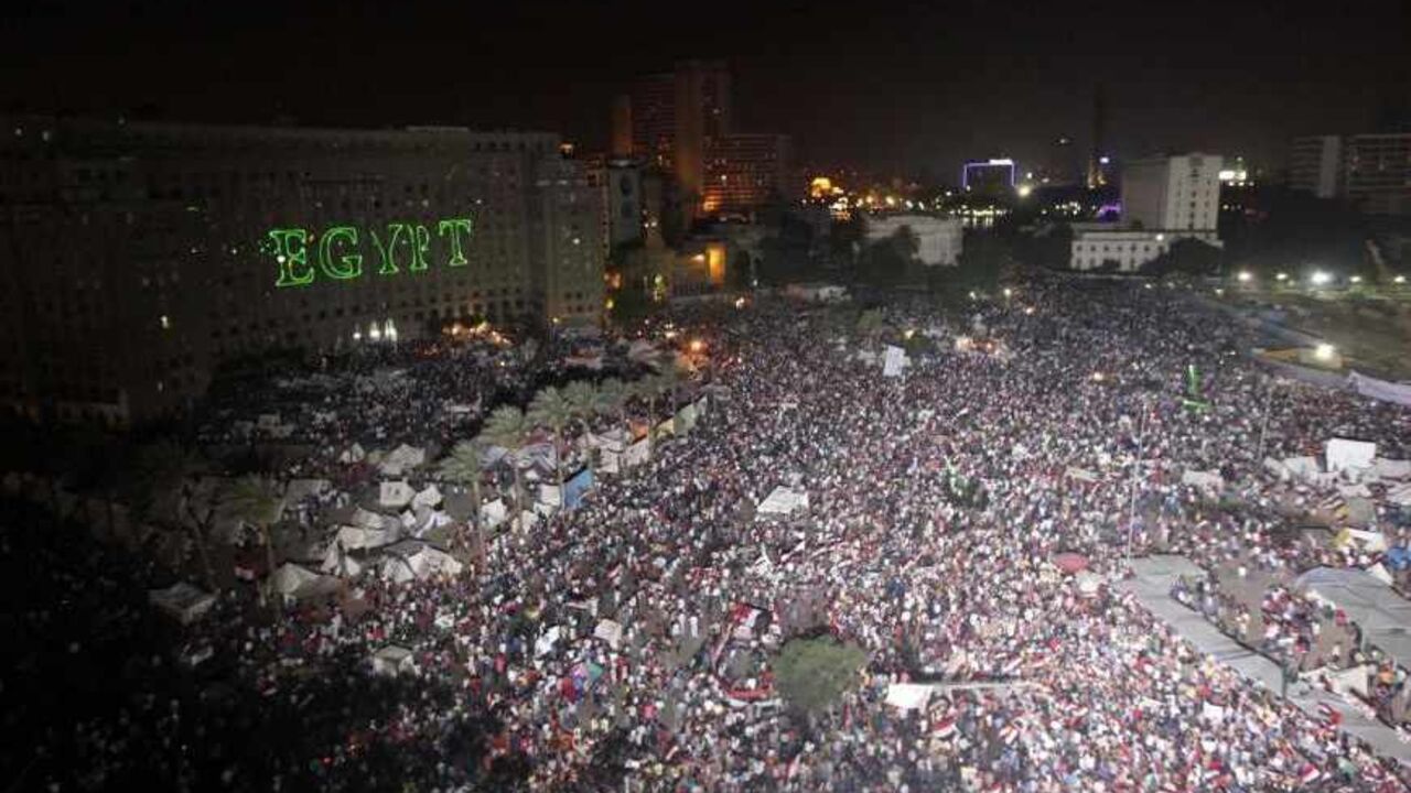 EGYPT-PROTESTS/ARMY Protesters opposing Egyptian President Mohamed Mursi use lasers to write "Egypt" on the Mogamma building, Egypt's biggest administrative building at Tahrir Square in Cairo July 2, 2013. Egypt's army reprised its role as hero in a new act of the country's political drama on Monday with a move celebrated by protesters as a decisive blow against an unpopular president just two and half years after the military unseated his predecessor. REUTERS/Mohamed Abd El Ghany (EGYPT - Tags: POLITICS CIVIL UNREST) - RTX11