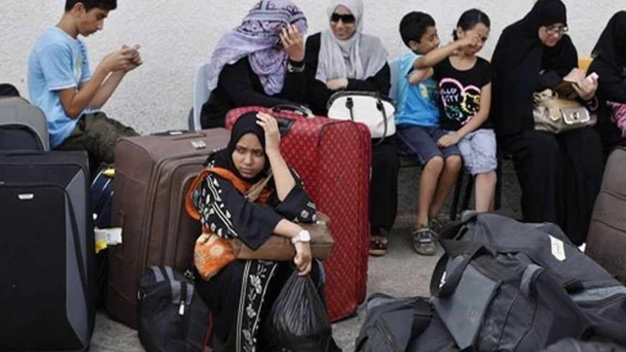 EGYPT-PROTESTS/PALESTINIANS Palestinian passengers wait to cross into Egypt at Rafah border crossing in the southern Gaza Strip July 10, 2013. Egypt opened its crossing with the Gaza Strip on Wednesday for several hours to allow stranded Palestinians to return to the enclave and for others to leave after five days of closure. Egyptian authorities ordered the passage closed last Friday after President Mohamed Mursi was removed and amid widescale protests in Egypt. REUTERS/Ibraheem Abu Mustafa (GAZA - Tags: POLITICS) - RTX11IJT