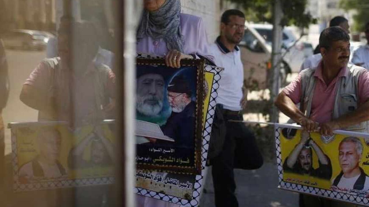 Palestinians hold up posters of prisoners during a protest calling for the release of Palestinian prisoners from Israeli jails near the Red Cross in Gaza City Palestinians hold up posters of prisoners during a protest calling for the release of Palestinian prisoners from Israeli jails near the Red Cross in Gaza City July 29, 2013. Israel's cabinet on Sunday approved the release of 104 Arab prisoners to help restart peace talks with the Palestinians and end nearly three years of diplomatic stagnation.Palestinian President Mahmoud Abbas has demanded the release of prisoners held since before a 1993 interim peace accord took effect. Israel has jailed thousands more