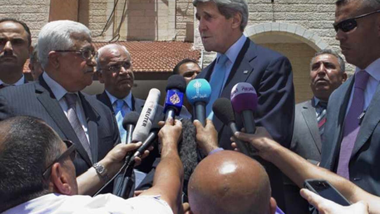 MIDEAST-USA-TALKS U.S. Secretary of State John Kerry (C), with Palestinian President Mahmoud Abbas (L), makes a short statement to the media after their meeting in the West Bank town of Ramallah June 30, 2013. Kerry ended a shuttle diplomacy mission on Sunday without an agreement on resuming Israeli-Palestinian peace talks but said gaps had been narrowed and he would return to the region soon. REUTERS/Jacquelyn Martin/Pool (WEST BANK - Tags: POLITICS) - RTX116U7