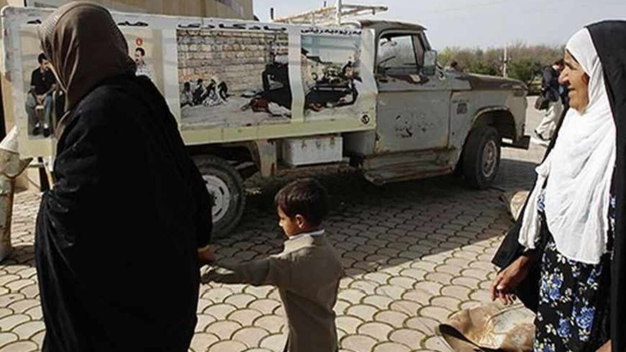 IRAQ/ Kurdish women walk past a truck that was hit in the 1988 chemical attack at the memorial site for victims of the attack in the Kurdish town of Halabja, near Sulaimaniya, 260 km (160 miles) northeast of Baghdad, March 16, 2013. Iraqi Kurds on Saturday marked the 25th anniversary of the chemical attack on the northern Iraqi city of Halabja by Saddam Hussein's forces. Up to 5,000 people may have been killed by chemical gas, villages were razed and thousands of Kurds were forced into camps during the 1988 Anfal