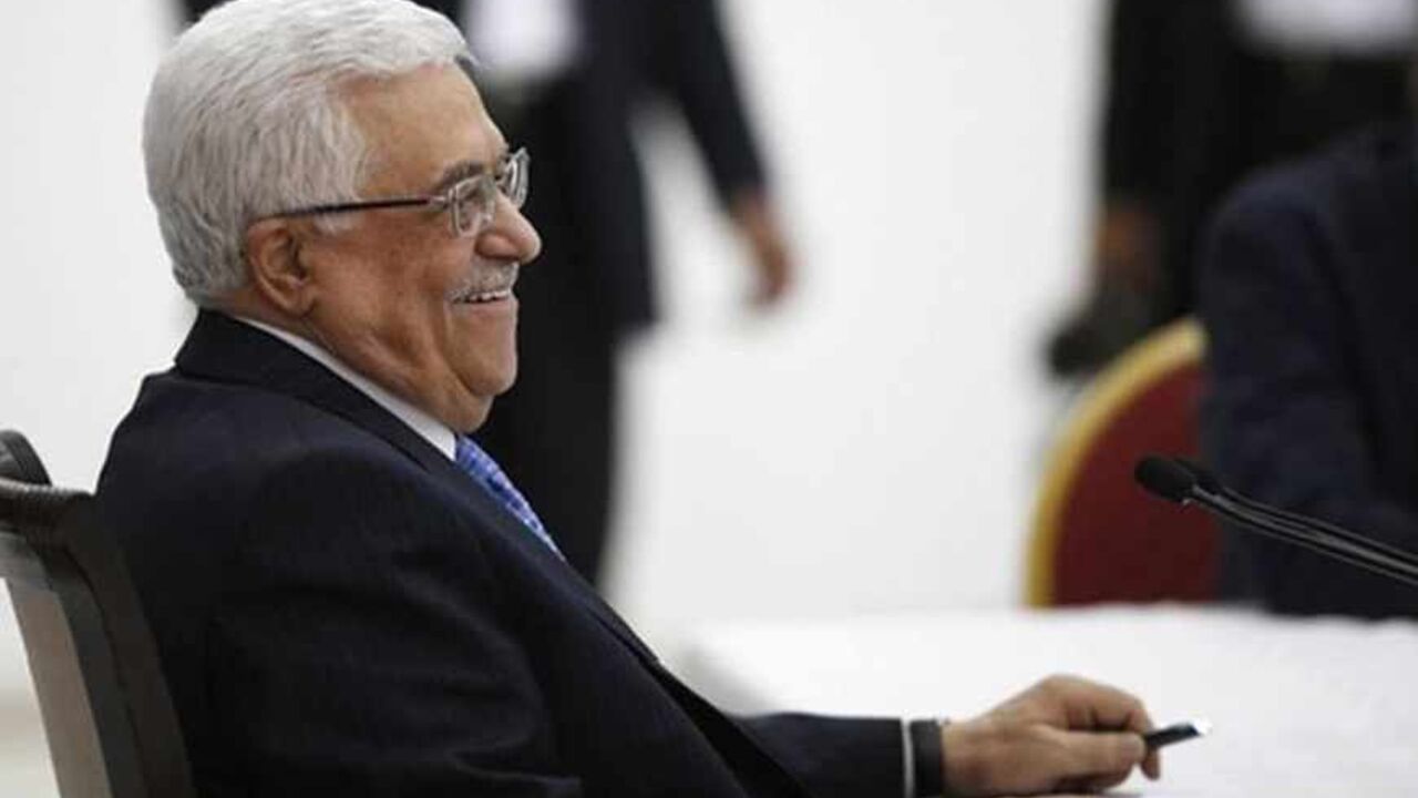 PALESTINIANS-ISRAEL/KERRY Palestinian President Mahmoud Abbas smiles during a meeting of the Palestinian leadership in the West Bank city of Ramallah July 18, 2013. As Palestinian leaders discussed a possible U.S-brokered resumption of peace talks on Thursday, the Israeli government denied a shift in its conditions that might help end a three-year stalemate. Abbas began briefing fellow PLO leaders in Ramallah on his meetings this week with U.S. Secretary of State John Kerry, who has extended his stay in the region and appears to be