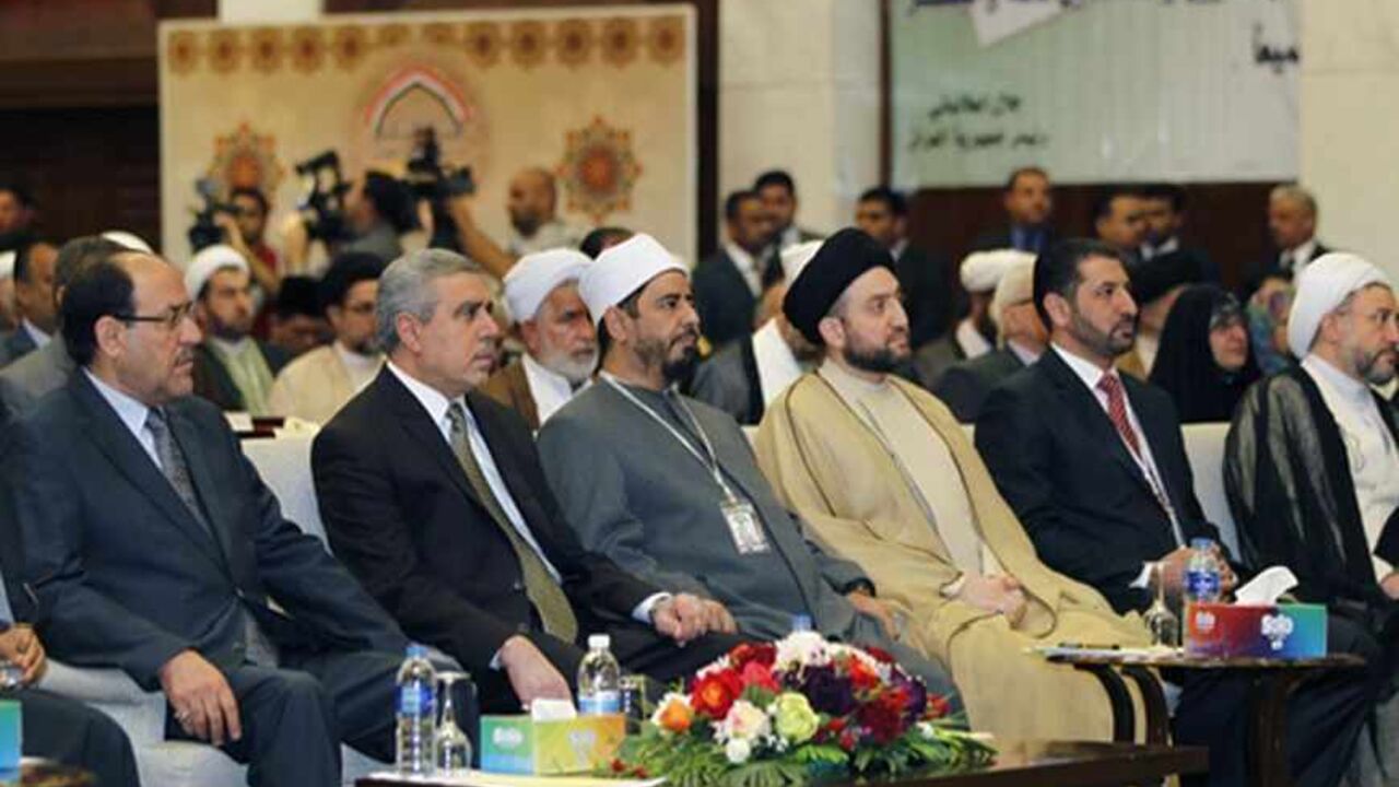 IRAQ/ Iraq's Prime Minister Nuri al-Maliki (L) attends the International Islamic Conference for the Convergence and Dialogue in Baghdad April 27, 2013. REUTERS/Mohammed Ameen (IRAQ - Tags: POLITICS RELIGION) - RTXZ1ML