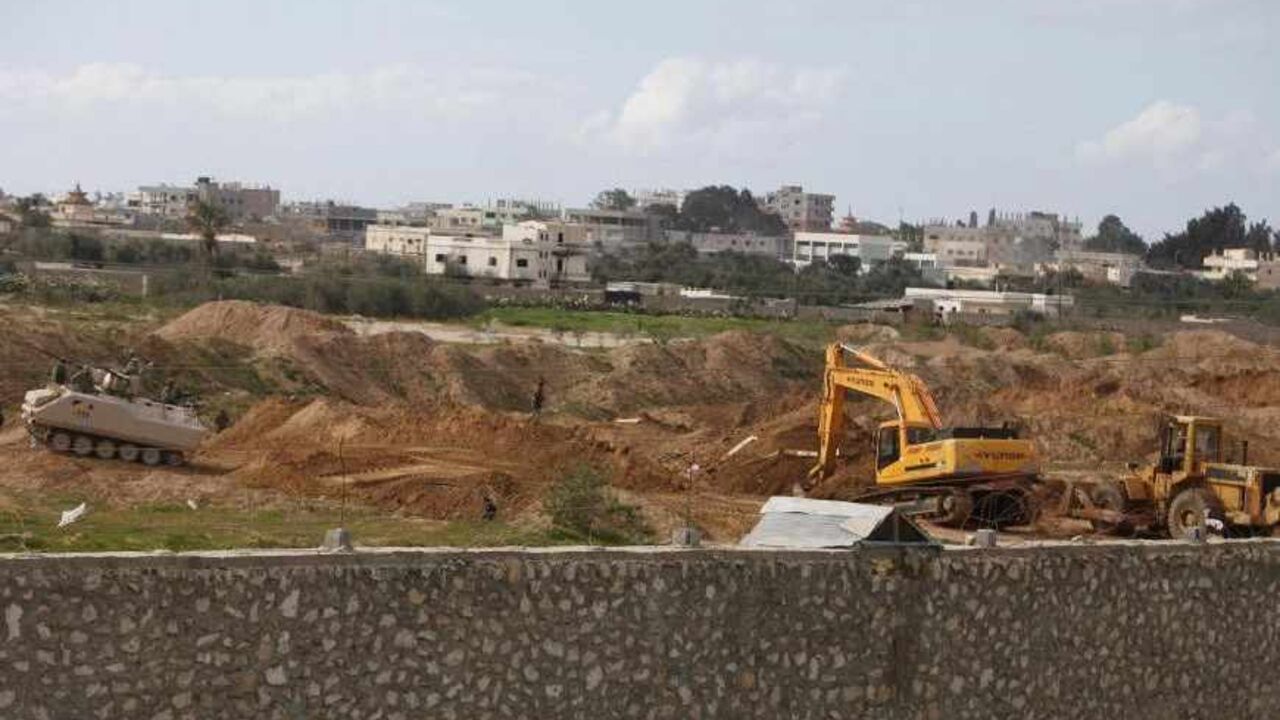 Egyptian soldiers keep guard as heavy equipment destroy smuggling tunnels beneath the Egyptian-Gaza border in Rafah Egyptian soldiers keep guard as heavy equipment destroy smuggling tunnels beneath the Egyptian-Gaza border in Rafah, in the southern Gaza Strip February 19, 2013. Egypt will not tolerate a two-way flow of smuggled arms with the Gaza Strip that is destabilising its Sinai peninsula, a senior aide to its Islamist president said, explaining why Egyptian forces flooded sub-border tunnels last week. To match Interview PALESTINIANS-TUNNELS/EGYPT REUTERS/Ibraheem Abu Mustafa (GAZA - Tags: POLITICS CIVIL UNREST)