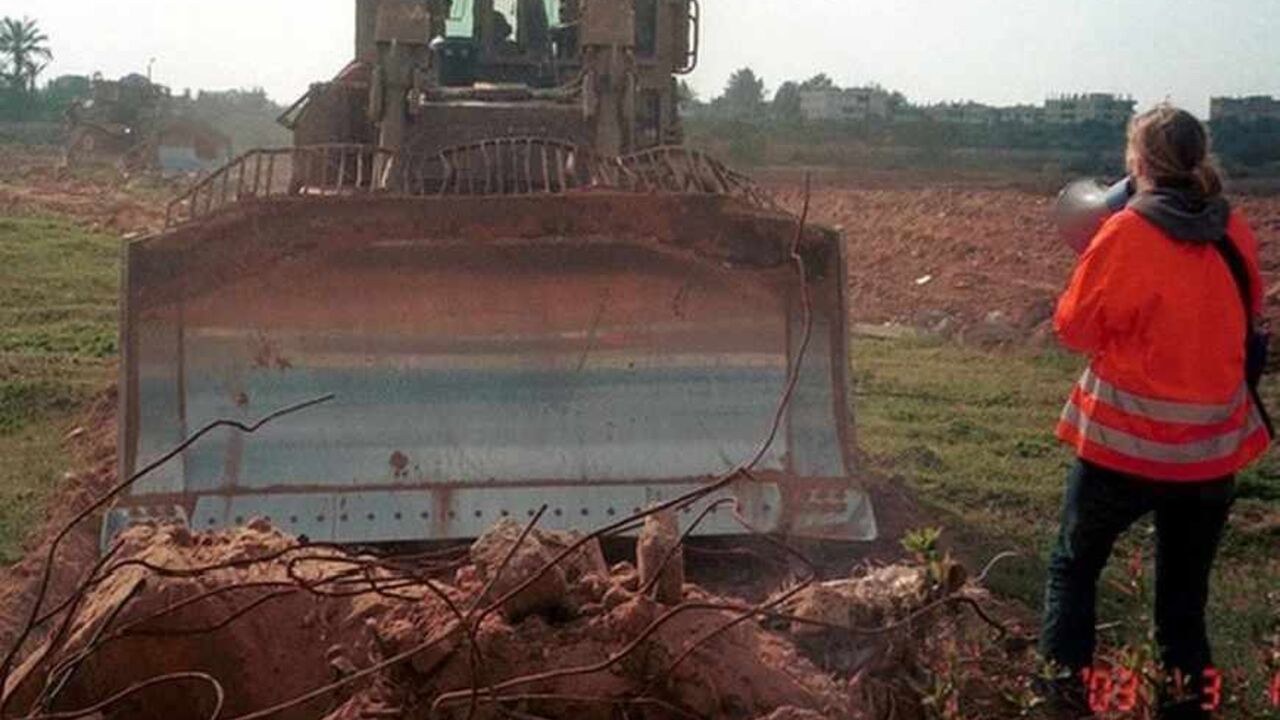 U.S. CITIZEN RACHEL COREY SPEAKS ON A MEGAPHONE TO AN ISRAELI ARMY
BULDOZER IN RAFAH. U.S. citizen Rachel Corrie 23, speaks through a megaphone to an Israeli army
bulldozer before she was killed in Rafah, Southern Gaza Strip March 16,
2003. An Israeli military bulldozer killed Corrie on Sunday who was
protesting the demolition of a house in the southern Gaza Strip on Sunday,
Palestinian medical officials and witnesses said. "The bulldozer put sand on
her and kept crushing her," said Nicholas Dure, a fellow member of the
International Solidarity Campaign to Protect the Palestinian Peopl