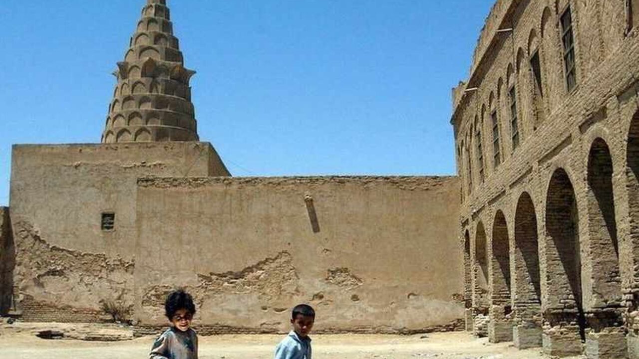 IRAQI CHILDREN WALK IN FRONT OF SHRINE IN IRAQI TOWN OF KIFL. Two children carrying food and water walk in front of the shrine
containing the tomb of Jewish prophet Ezekiel in the Iraqi town of
Kifl, 140 km south of Baghdad, on Wednesday, July 16,2003. The town,
which has drawn visitors from across Iraq and beyond because of the
shrine and its picturesque ancient market, was the scene of a fierce
battle in which hundreds of people died during the Iraq war but it is
now bustling again. REUTERS/Stefano Rellandini REUTERS
SR/CLH/ - RTRL2O