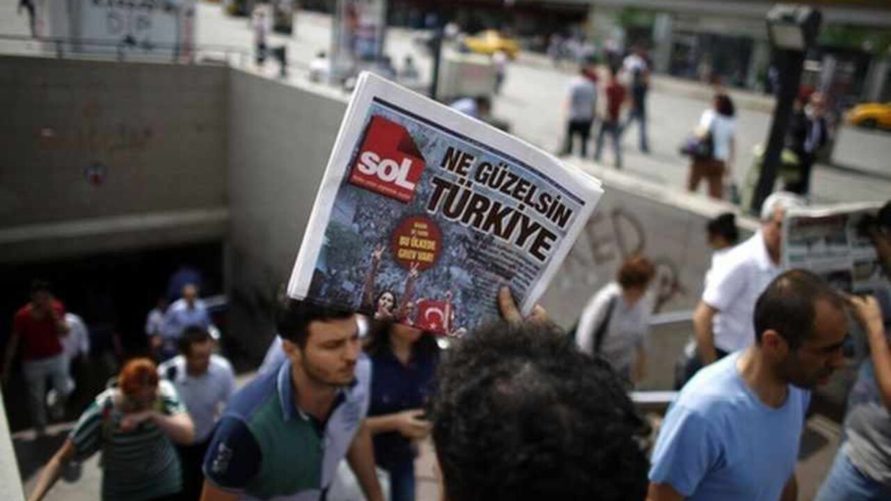 A man sells newspapers to people as they leave the subway station at Taksim Square in Istanbul A man sells newspapers to people as they leave the subway station at Taksim Square in Istanbul June 4, 2013. Pockets of protesters clashed with Turkish riot police overnight and a union federation began a two-day strike on Tuesday as anti-government demonstrations in which two people have died stretched into a fifth day. Hundreds of police and protesters have been injured since Friday, when a demonstration to halt construction in a park in an Istanbul square grew into mass protests against a heavy-handed po