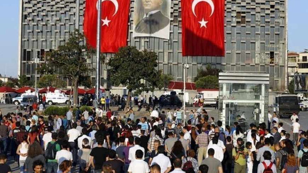 People stand facing Ataturk Cultural Center during a protest at Taksim Square in Istanbul June 18, 2013. Performance artist Erdem Gunduz became the new symbol of anti-government protests in Turkey on Tuesday after his eight-hour vigil in Taksim Square earned him the nickname "the Standing Man". Gunduz said he was protesting in solidarity with demonstrators who were evicted at the weekend from Gezi Park adjoining Taksim, an intervention by police that triggered some of the most violent clashes to date. What 