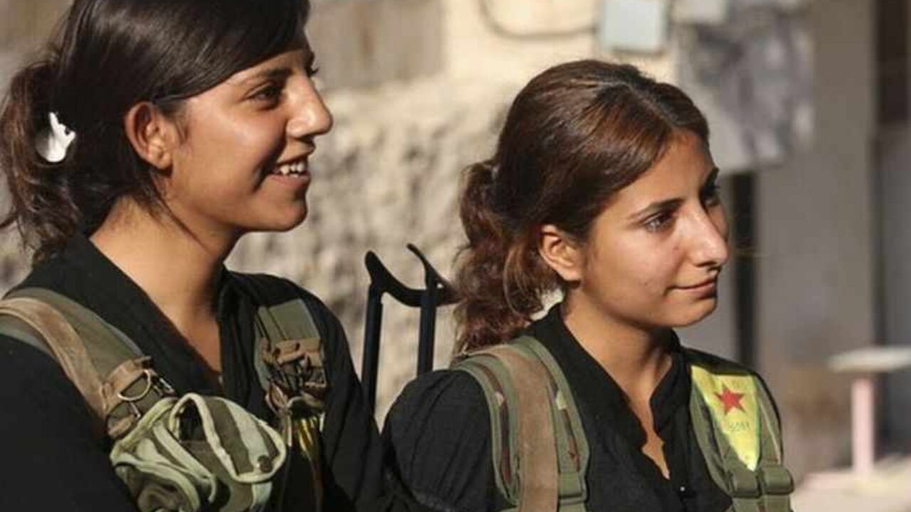 Kurdish fighters from the YPG stand along a street in Aleppo's Sheikh Maqsoud neighborhood Kurdish fighters from the Popular Protection Units (YPG), wearing vests with the YPG logo, stand along a street in Aleppo's Sheikh Maqsoud neighborhood, June 19, 2013. Kurdish fighters from the Popular Protection Units (YPG) joined the Free Syrian Army to fight against forces loyal to Syria's President Bashar al-Assad. Picture taken June 19, 2013. REUTERS/Nour Kelze (SYRIA - Tags: POLITICS CIVIL UNREST CONFLICT) - RTX10UJS