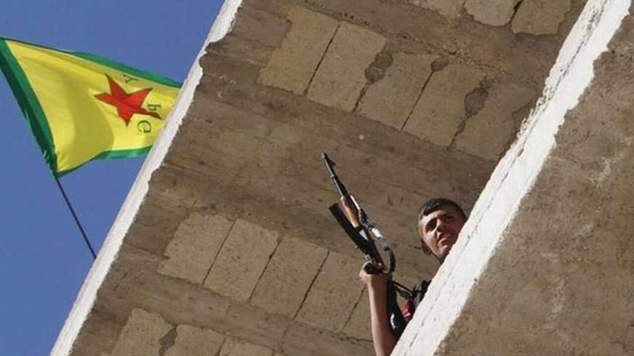 A Kurdish fighter from the Popular Protection Units holds his weapon as he takes position atop a building in Aleppo's Sheikh Maqsoud neighbourhood A Kurdish fighter from the Popular Protection Units (YPG) holds his weapon as he takes position atop a building with a YPG flag in Aleppo's Sheikh Maqsoud neighbourhood, June 7, 2013. Kurdish fighters from the YPG joined the Free Syrian Army to fight against forces loyal to Syria's President Bashar al-Assad. Picture taken June 7, 2013. REUTERS/Muzaffar Salman (SYRIA - Tags: CIVIL UNREST POLITICS CONFLICT) - RTX10USX