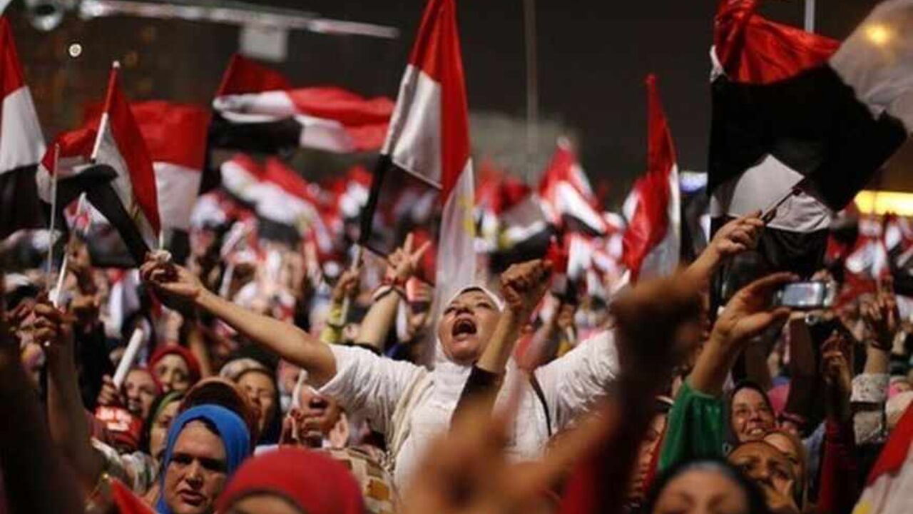 Protesters, who are against Egyptian President Mohamed Mursi, react in Tahrir Square in Cairo July 3, 2013. The head of Egypt's armed forces General Abdel Fattah al-Sisi issued a declaration on Wednesday suspending the constitution and appointing the head of the constitutional court as interim head of state, effectively declared the removal of elected Islamist President Mohamed Mursi. REUTERS/Suhaib Salem (EGYPT - Tags: POLITICS CIVIL UNREST TPX IMAGES OF THE DAY) - RTX11BNS