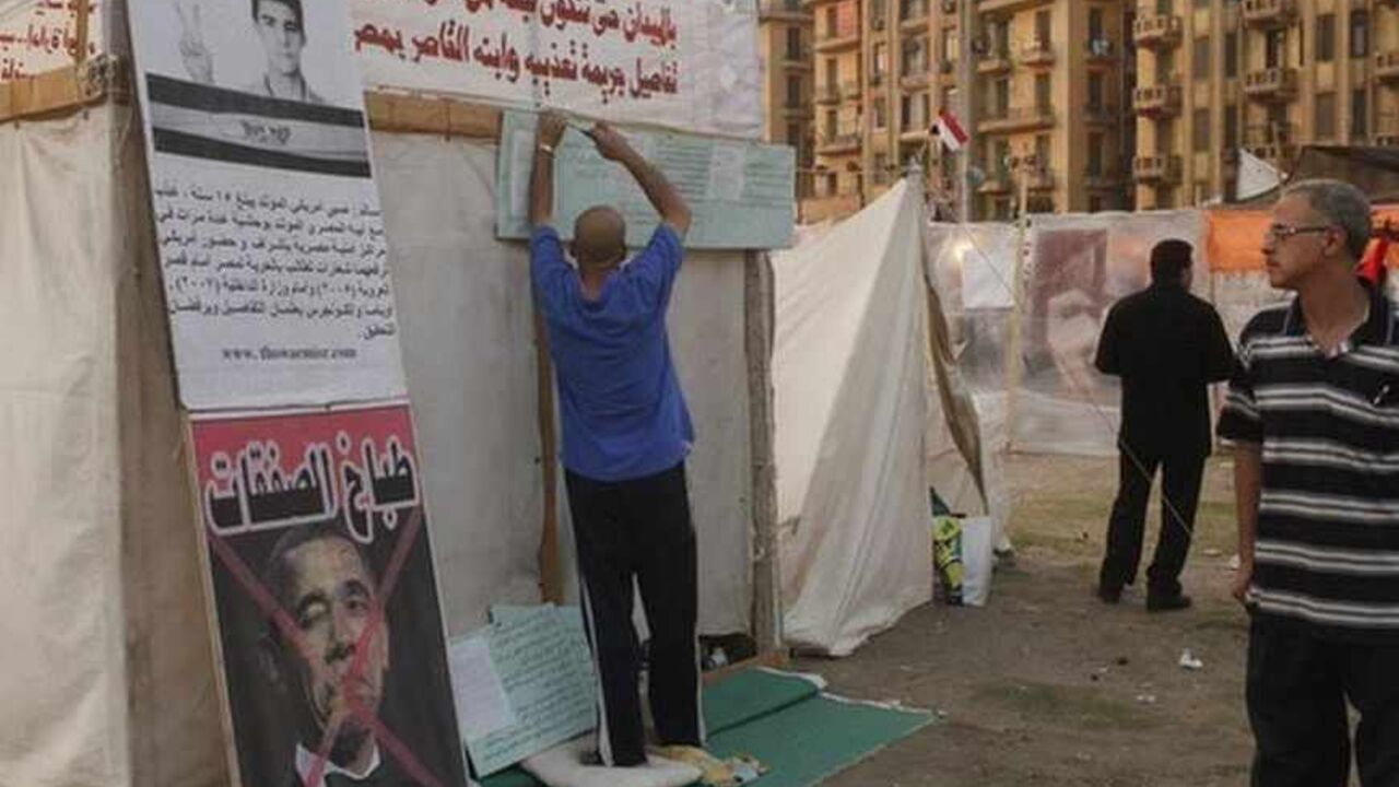 A protester hangs placards on his tent as a crossed-out picture of U.S. President Barack Obama is seen, in Tahrir square, Cairo A protester hangs placards on his tent as a crossed-out picture of U.S. President Barack Obama is seen, in Tahrir square, Cairo, July 15, 2013. The first senior U.S. official to visit Egypt since the army toppled its elected president was snubbed by both Islamists and their opponents on Monday.
Deputy Secretary of State William Burns arrived in a divided capital where both sides are furious at the United States, the superpower which supports Egypt with $1.5 billion in annual aid, mostly for the army that d