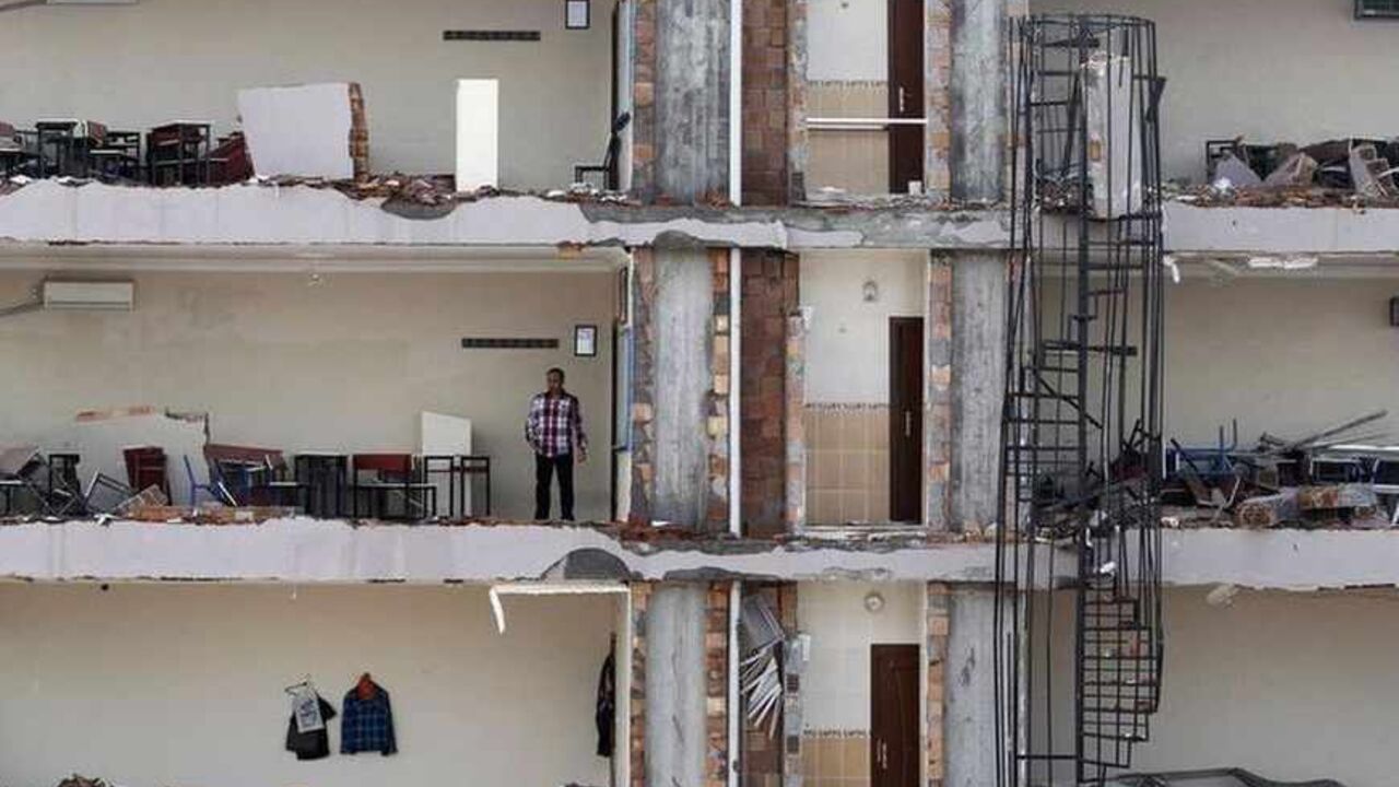 A man checks an apartment on a damaged building at the site of a blast in Reyhanli A man checks an apartment on a damaged building at the site of a blast in the town of Reyhanli in Hatay province, near the Turkish-Syrian border, May 13, 2013. Syria's information minister has blamed Turkey's government for deadly car bombings near the Syrian border and branded Prime Minister Tayyip Erdogan a "murderer", state-run Russian TV company RT reported on Monday. It said he repeated a denial of Syrian involvement in car bombings that killed 46 people on Saturday in the Turkish border town of Reyhan