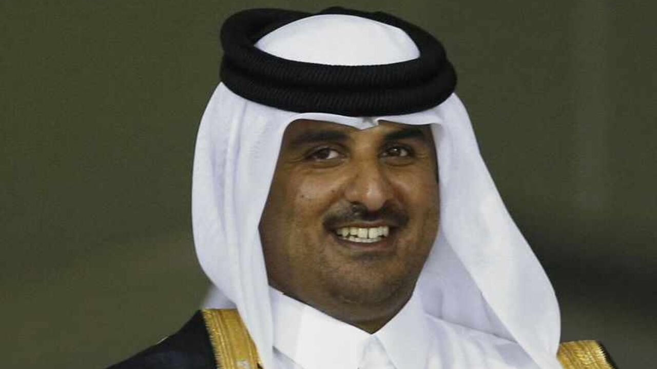 Madjid Bougherra (R) of Lekhwiya receives the trophy from Qatar's Crown Prince Sheikh Tamim bin Hamad al-Thani at Al-Sadd Stadium after the final match of the Crown Prince Cup soccer tournament against Al-Sadd in Doha May 4, 2013.    REUTERS/Fadi Al-Assaad (QATAR - Tags: SPORT SOCCER ROYALS) - RTXZAGP
