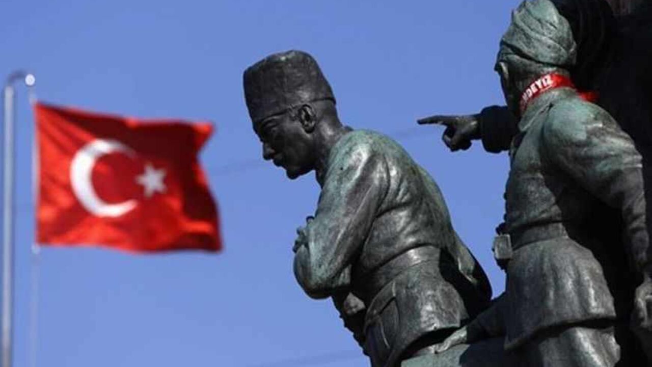 TURKEY/ A Turkish flag flutters near the monument of Mustafa Kemal Ataturk at Taksim Square in Istanbul June 24, 2013. REUTERS/Marko Djurica (TURKEY - Tags: SOCIETY) - RTX10Z87