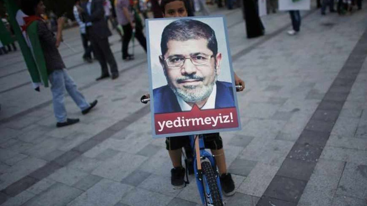A boy balances a poster of Egypt's President Mursi on his bicycle during a pro-Islamist demonstration in Istanbul A boy balances a poster of Egypt's President Mohamed Mursi on his bicycle during a pro-Islamist demonstration in Istanbul July 1, 2013. Pro-Islamist groups held a demonstration in Istanbul in support of Mursi on Tuesday. Egypt's armed forces handed Islamist President Mohamed Mursi a virtual ultimatum to share power on Monday, giving feuding politicians 48 hours to compromise or have the army impose its own road map for the country. The slogan on the poster reads, " We will not let you victimise him". REUTER