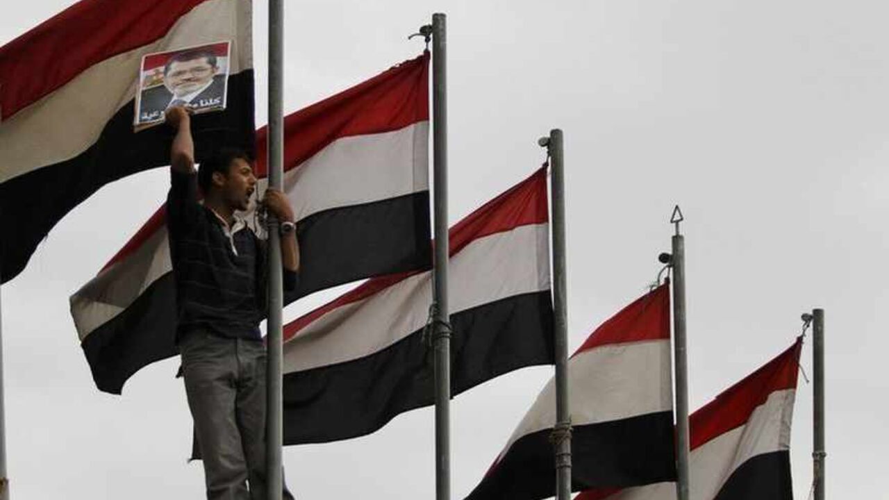 A protester holds a picture of deposed Egyptian President Mohamed Mursi during a pro-democracy demonstration in Sanaa A protester holds a picture of deposed Egyptian President Mohamed Mursi during a pro-democracy demonstration in Sanaa July 8, 2013. REUTERS/Mohammed al-Sayaghi (YEMEN - Tags: POLITICS CIVIL UNREST) - RTX11GUB