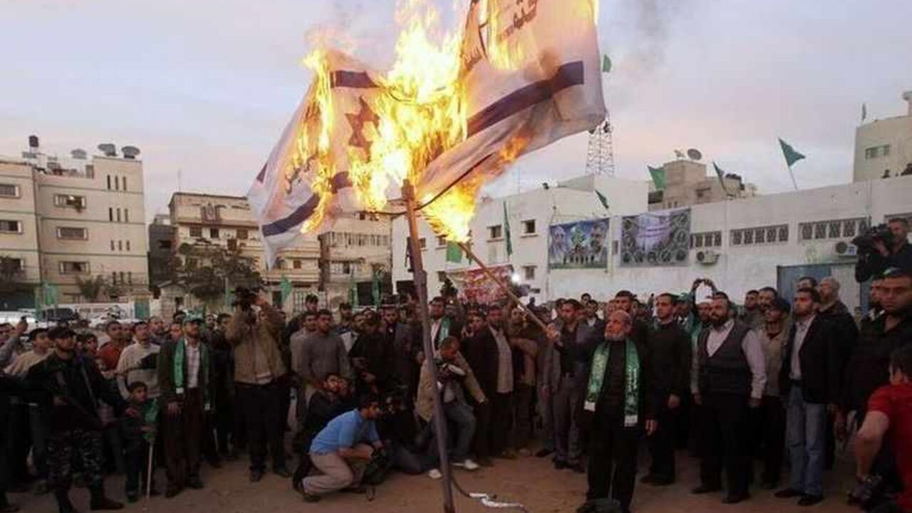 Senior Hamas leader Mahmoud al-Zahar burns Israeli flags in Gaza city in preparation for the movement's 23rd anniversary next week Senior Hamas leader Mahmoud al-Zahar burns Israeli flags in Gaza city in preparation for the movement's 23rd anniversary next week December 9, 2010. REUTERS/Mohammed Salem (GAZA - Tags: POLITICS ANNIVERSARY CIVIL UNREST) - RTXVKMR