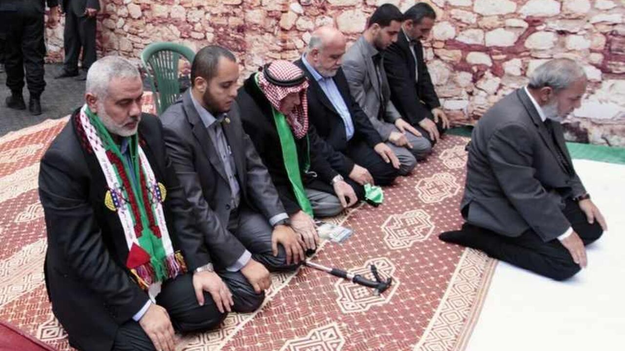 Senior Hamas leaders Haniyeh and Al-Zahar pray during a rally marking 25th anniversary of the founding of Hamas, in Gaza City Senior Hamas leaders Ismail Haniyeh (L) and Mahmoud Al-Zahar (R) pray at the stage during a rally marking the 25th anniversary of the founding of Hamas, in Gaza City December 8, 2012. Hamas leader Khaled Meshaal, in an uncompromising speech during his first ever visit to Gaza after decades of exile, told a mass rally on Saturday he would never recognise Israel and pledged to "free the land of Palestine inch by inch". REUTERS/Ahmed Jadallah (GAZA - Tags: POLITICS ANNIVERSARY CIVIL UNREST RELIGION) - RTR3BCZ