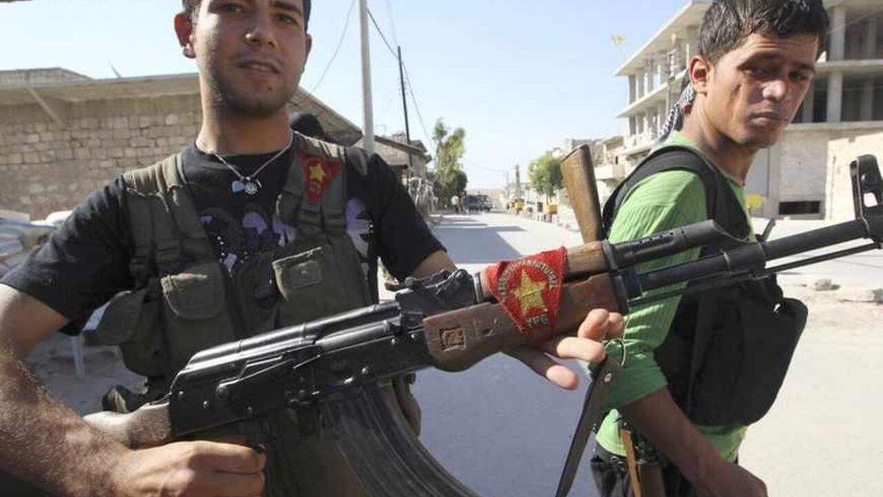 A Kurdish fighter from the Popular Protection Units shows his weapon decorated with his party's flag, as a fellow fighter looks on in Aleppo's Sheikh Maqsoud neighbourhood A Kurdish fighter from the Popular Protection Units (YPG) shows his weapon decorated with his party's flag, as a fellow fighter looks on in Aleppo's Sheikh Maqsoud neighbourhood, June 7, 2013. Kurdish fighters from the YPG joined the Free Syrian Army to fight against forces loyal to Syria's President Bashar al-Assad. Picture taken June 7, 2013. REUTERS/Muzaffar Salman (SYRIA - Tags: CIVIL UNREST POLITICS CONFLICT) - RTX10UT2
