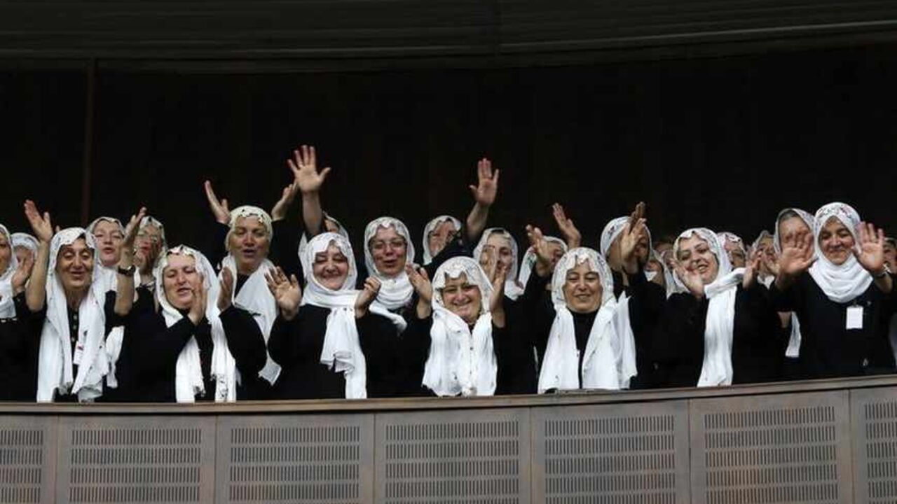 Supporters of Turkey's Prime Minister Erdogan cheer as he addresses the members of parliament from his ruling AK Party during a meeting at Turkish parliament in Ankara Supporters of Turkey's Prime Minister Tayyip Erdogan (not pictured) cheer as he addresses the members of parliament from his ruling AK Party (AKP) during a meeting at Turkish parliament in Ankara June 25, 2013. Turkish anti-terrorism police detained 20 people in raids in the capital Ankara on Tuesday in connection with weeks of anti-government protests across the country, media reports said. REUTERS/Umit Bektas (TURKEY - Tags: POLITICS) - RTX11029
