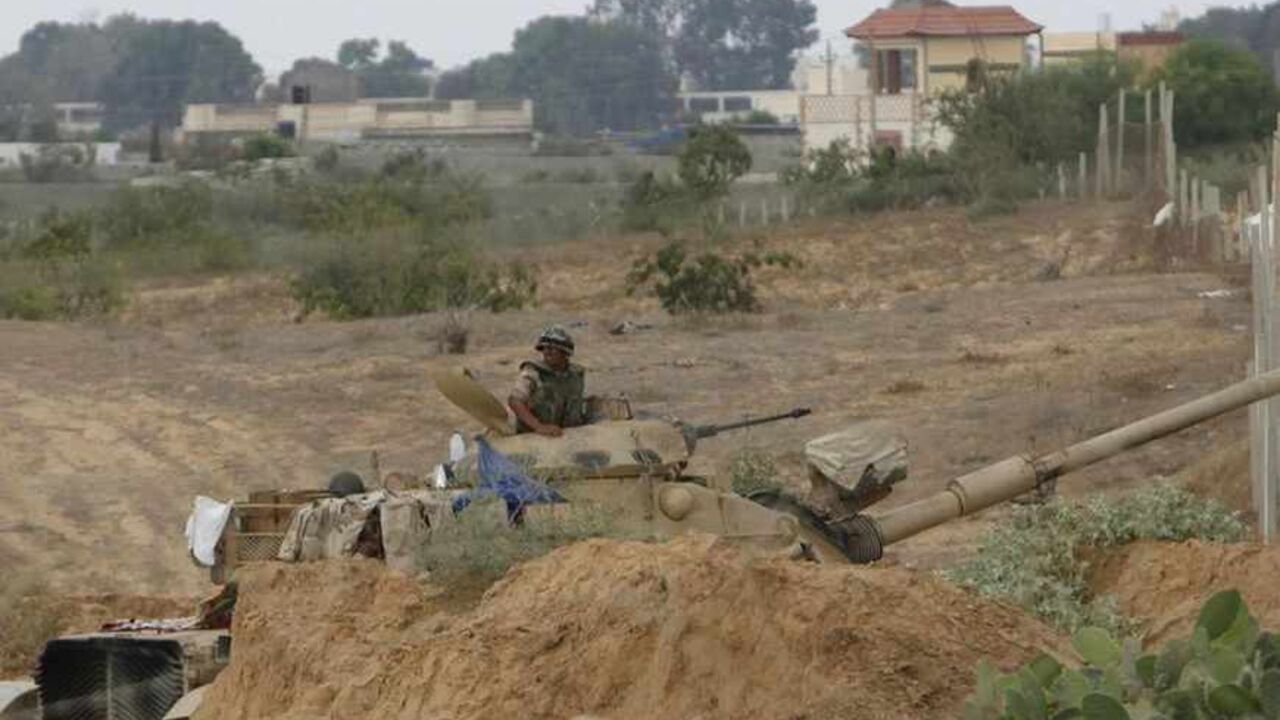An Egyptian soldier keeps guard on the border between Egypt and southern Gaza Strip An Egyptian soldier keeps guard on the border between Egypt and southern Gaza Strip July 8, 2013. Armed men launched a series of attacks on Sunday on security checkpoints in the North Sinai towns of Sheikh Zuweid and El Arish close to Egypt's border with Israel and the Gaza Strip, and one soldier was killed. The Rafah border crossing between Egypt and Gaza Strip remained closed since Friday.
REUTERS/Ibraheem Abu Mustafa (GAZA - Tags: POLITICS CIVIL UNREST MILITARY) - RTX11GFL