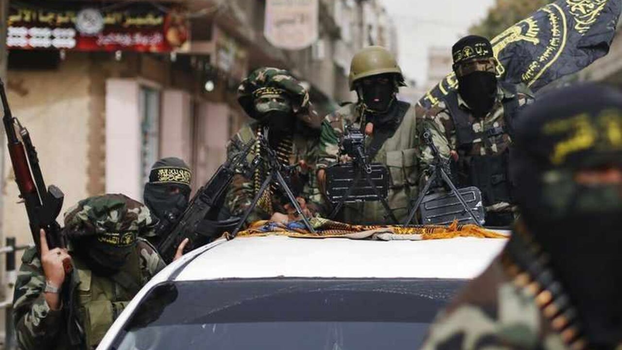 Islamic Jihad militants ride on a pickup truck as they follow the convoy of freed Palestinian prisoner Baroud, upon his arrival in the northern Gaza Strip Islamic Jihad militants ride on a pickup truck as they follow the convoy of freed Palestinian prisoner Ibrahim Baroud, upon his arrival in the northern Gaza Strip April 8, 2013. Baroud, who was convicted of his affiliation with the armed group of Islamic Jihad and for carrying out armed attacks against Israel, was released on Monday after serving 27 years in an Israeli jail, according to media reports. REUTERS/Mohammed Salem (GAZA - Tags: POLITICS) - RTXYD6V