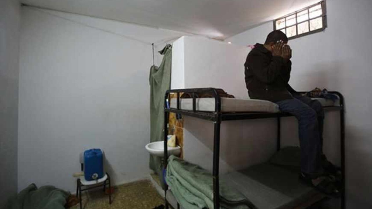 PALESTINIANS-HAMAS/SPIES An alleged Palestinian collaborator with Israel covers his face as he poses for the camera inside a Hamas-run prison in Gaza City April 23, 2013. The Islamist Hamas government, which is pledged to Israel's destruction by force of arms, is lauding a recent campaign to root out informants in its midst, which it hopes will deprive Israel of a subtle but effective tool. Picture taken April 23, 2013. To match Feature PALESTINIANS-HAMAS/SPIES REUTERS/Suhaib Salem (GAZA - Tags: POLITICS TPX IMAGES OF THE DAY) -