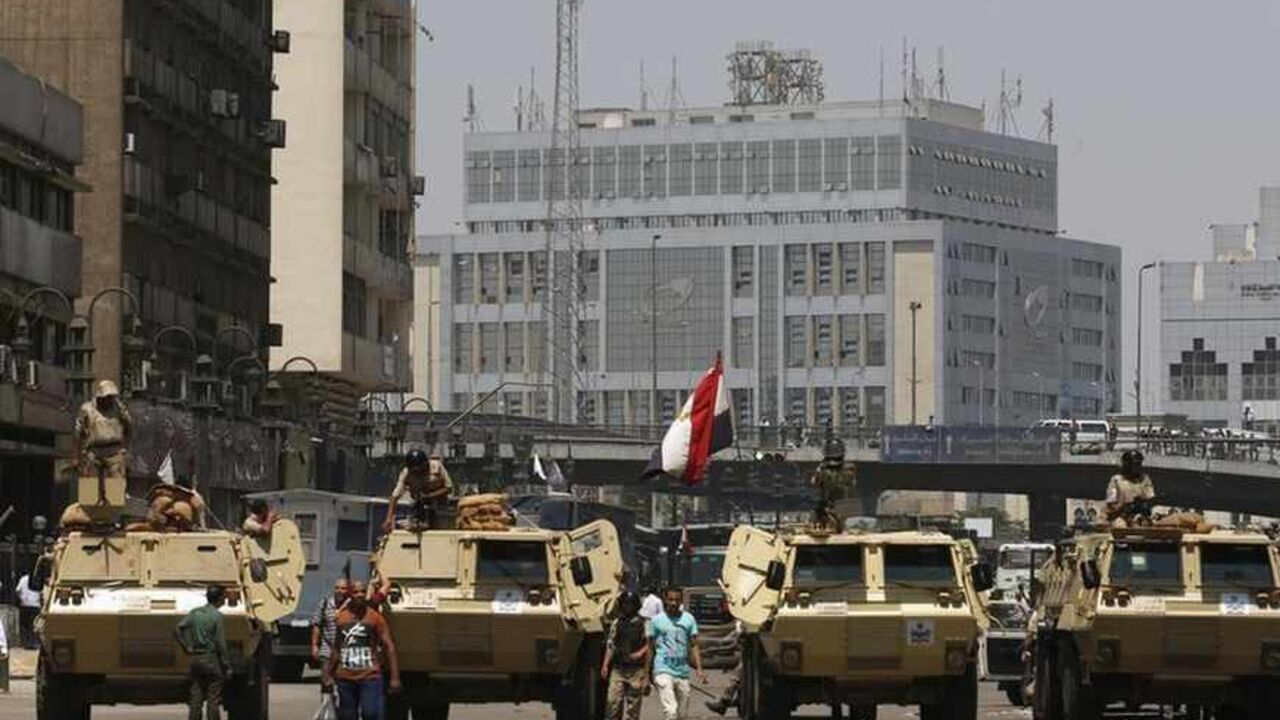 Soldiers stand guard on an armoured personnel carrier positioned outside Ramses Square, near al-Fath mosque in Cairo August 17, 2013. Egyptian authorities rounded up more than 1,000 Islamists as the Muslim Brotherhood leadership defiantly called a week of nationwide protests starting on Saturday after a day of carnage. After Friday's bloodshed in which more than 100 people died in clashes that pushed Egypt ever closer to anarchy, tensions were high with supporters of ousted Islamist President Mohamed Mursi 