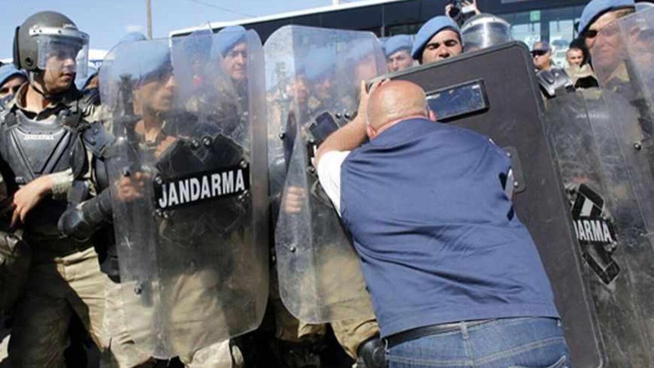 TURKEY-ERGENEKON/ A protester pushes into Turkish soldiers during clashes near Silivri, where a hearing on people charged with attempting to overthrow Prime Minister Tayyip Erdogan's Islamist-rooted government is due to take place August 5, 2013. A Turkish court on Monday sentenced a former military commander to life in prison and dozens of others including opposition members of parliament to long terms for plotting against the government, in a case that has exposed deep divisions in the country. Retired military chief of st
