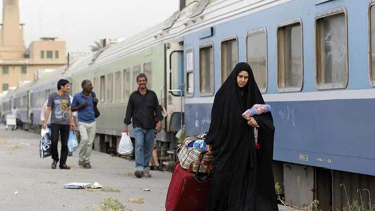 IRAQ-TRAINS/ A passenger walks beside a train in a train station in Baghdad May 6, 2013. Iraq's infrastructure is dilapidated after decades of war, sanctions and economic decline. In a country where piles of rubble and incomplete buildings are commonplace, almost every sector needs investment, including electricity and the sewage system. But the country is laying plans to rebuild its historic railways and become a transit hub for goods that would be shipped from Asia to Iraq’s neighbours and beyond. Iraq's railways date