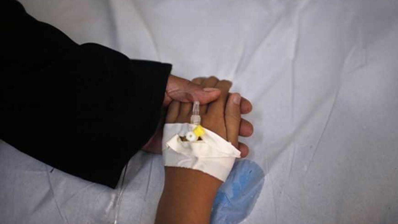 PALESTINIANS/ Cancer patient and blind Palestinian girl Aseel al-Haj Ahmed, 9, holds her mother's hand as she receives a regular treatment in a hospital in Gaza City April 29, 2013. Al-Haj Ahmed was afflicted with cancer when she was four months old, when doctors had to remove both her eyes and replace them with ocular prostheses as a result of a malignant tumour that struck her spinal cord. The schoolgirl is looked after by her unemployed father whose impoverished family includes his wife and four other children. Al-Haj