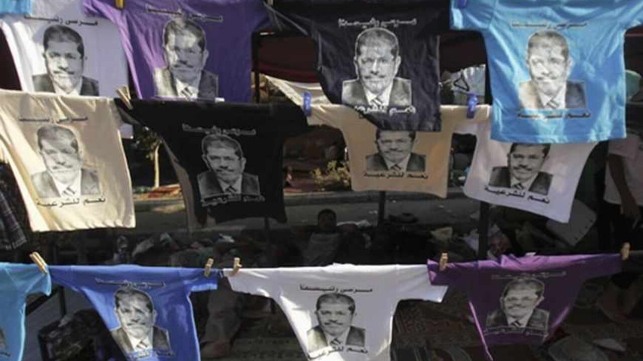 EGYPT-PROTESTS/ Members of the Muslim Brotherhood and supporters of deposed Egyptian President Mohamed Mursi display T-shirts with pictures of Mursi for sale ahead of Eid al-Fitr celebrations marking the end of the Islamic fasting month of Ramadan from Thursday to Sunday, at Rabaa Adawiya Square, where they are camping, in Nasr City, east of Cairo August 7, 2013. Egypt's political crisis entered a tense new phase on Wednesday after international mediation efforts collapsed and the army-installed government repeated its thr