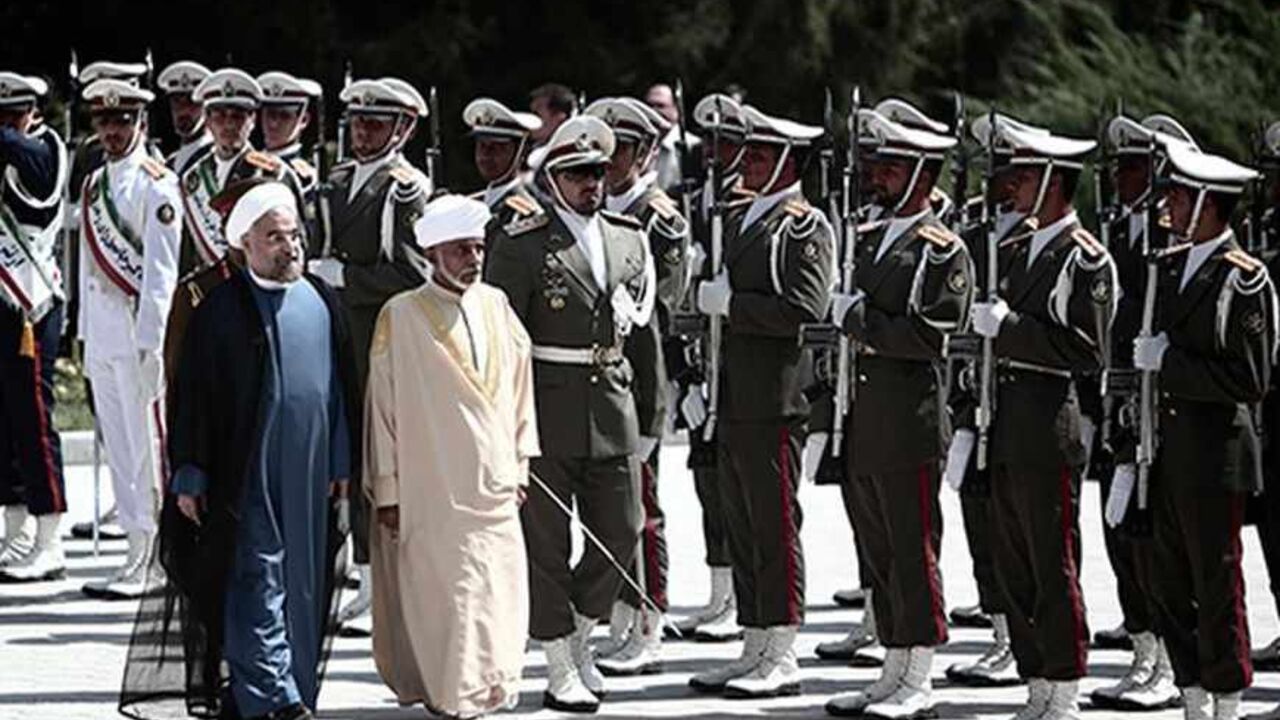 Iranian President Hassan Rowhani (L) and Oman's Sultan Qaboos bin Said (C-R) review the honour guard during the latter's welcoming ceremony at Tehran's Saadabad Palace on August 25, 2013. The Iranian authorities have announced that Sultan Qaboos of Oman, the only Gulf leader to maintain good relations with Tehran, arrived in Iran for a focus on economic issues and diplomacy visit. AFP PHOTO/BEHROUZ MEHRI        (Photo credit should read BEHROUZ MEHRI/AFP/Getty Images)