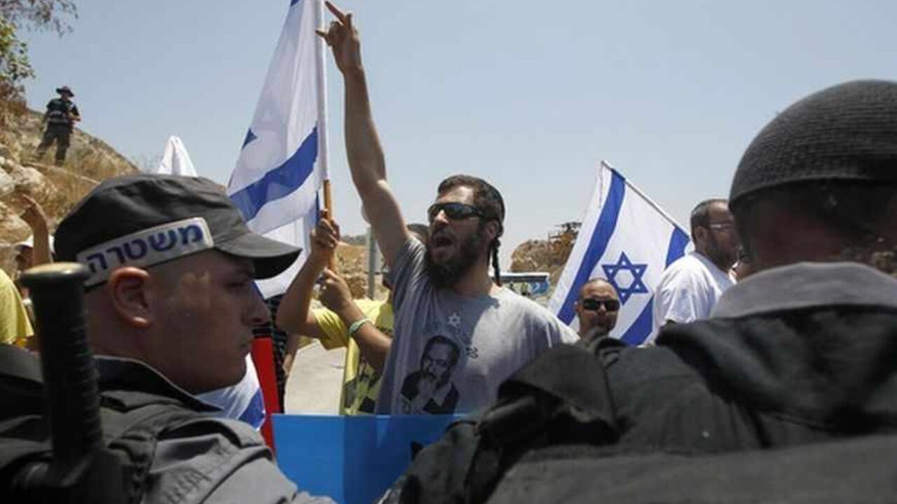 A Jewish ultranationalist shouts slogans during a rally in Nazareth calling to draft Israeli Arabs A Jewish ultranationalist shouts slogans in front of Israeli police during a rally in Nazareth, Israel's largest Arab town, calling to draft Israeli Arabs July 15, 2012. Military service is a rite of passage for most Israelis, who view the army as a core element of national identity. That is where the problem starts for many Arabs, who associate more closely with the Palestinians and feel alienated in a country created in 1948 that defines itself as a Jewish state. REUTERS/Baz Ratner (ISRAEL - Tags: POLITIC