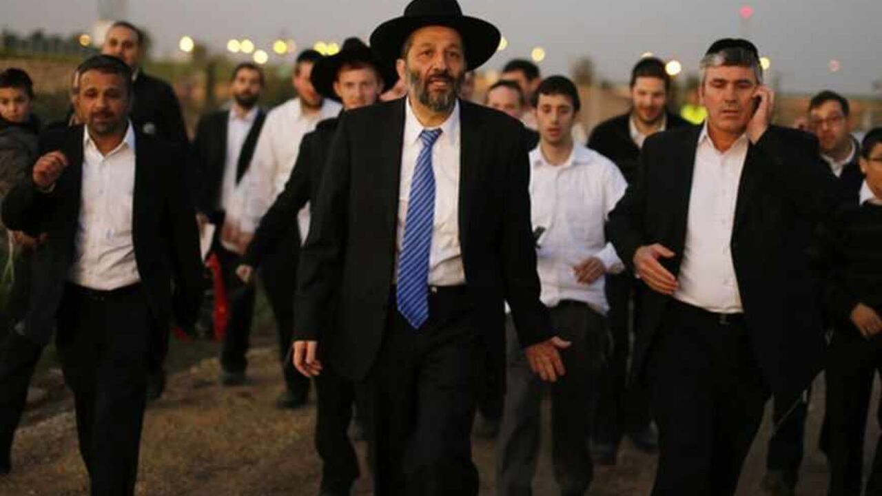 Deri, leader of the ultra-Orthodox Shas party attends an annual pilgrimage to the gravesite of Rabbi Abuhatzeira in Netivot Aryeh Deri (C), leader of the ultra-Orthodox Shas party, attends an annual pilgrimage to the gravesite of Rabbi Yisrael Abuhatzeira, a Moroccan-born sage and kabbalist also known as the Baba Sali, in the southern town of Netivot January 14, 2013. Powerful political players for years, Israel's ultra-Orthodox parties must now reckon with a new force ushered in by voters bent on stripping them of perks they have relied on for decades. Picture taken January 14, 2013. REUTERS/Amir Cohen (ISRAEL - Tags: POLITICS