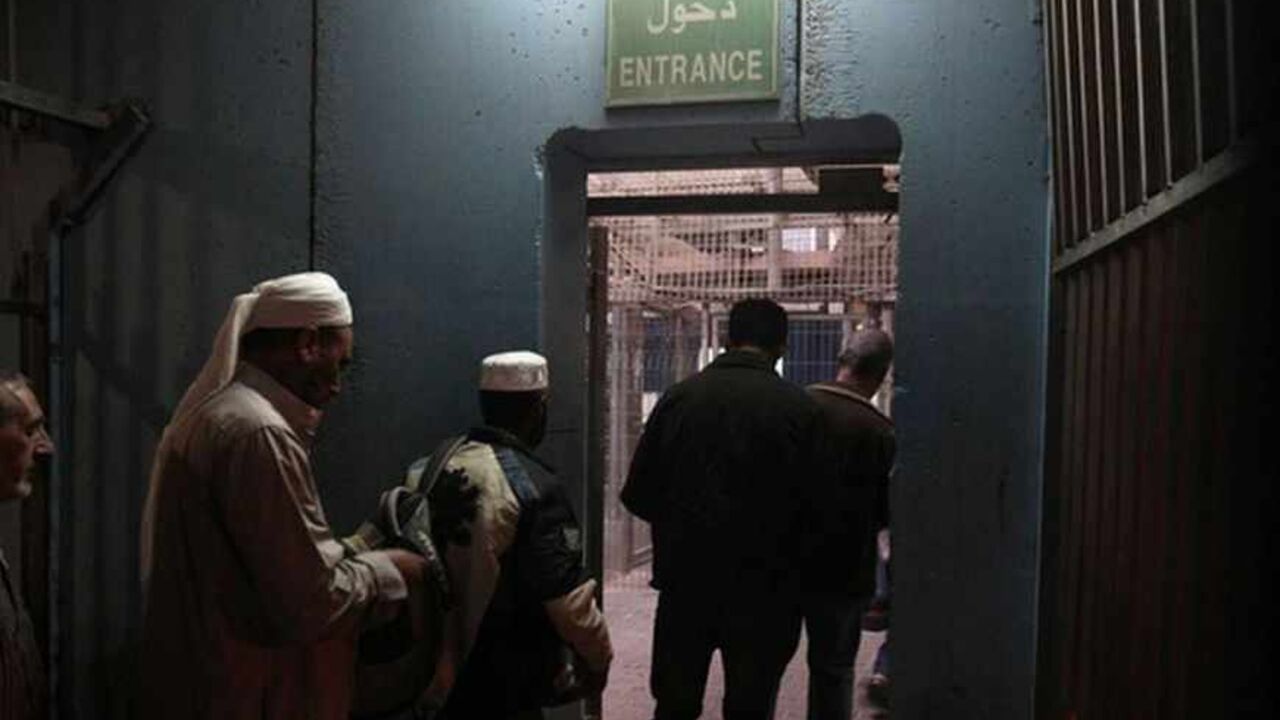 Palestinians wait to cross into Jerusalem at an Israeli checkpoint in the West Bank town of Bethlehem July 7, 2013. There are two ways for Palestinian workers to cross into Israel every day. Those with work permits can pass through a military checkpoint. Those without have to find a way through the separation barrier, which is made up of mostly fences and some cement walls, snaking its way through the West Bank. Those caught entering illegally risk a fine or imprisonment. Both ways are time consuming but th