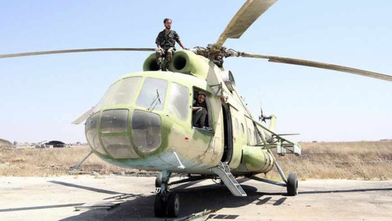 Free Syrian Army fighters are seen on a Russian-made helicopter that belonged to the Syrian Army at the Minnig Military Airport, after it was seized by the rebels Free Syrian Army fighters are seen on a Russian-made helicopter that belonged to the Syrian Army at the Minnig Military Airport, after it was seized by the rebels August 11, 2013. Syrian rebels captured the main military airport near the border with Turkey on August 6, consolidating their hold on a key supply route north of the city of Aleppo, opposition activists said. REUTERS/Mahmoud Hassano (SYRIA - Tags: CIVIL UNREST CONFLICT MILITARY TPX IMAGES OF THE DAY) - RTX12H8L