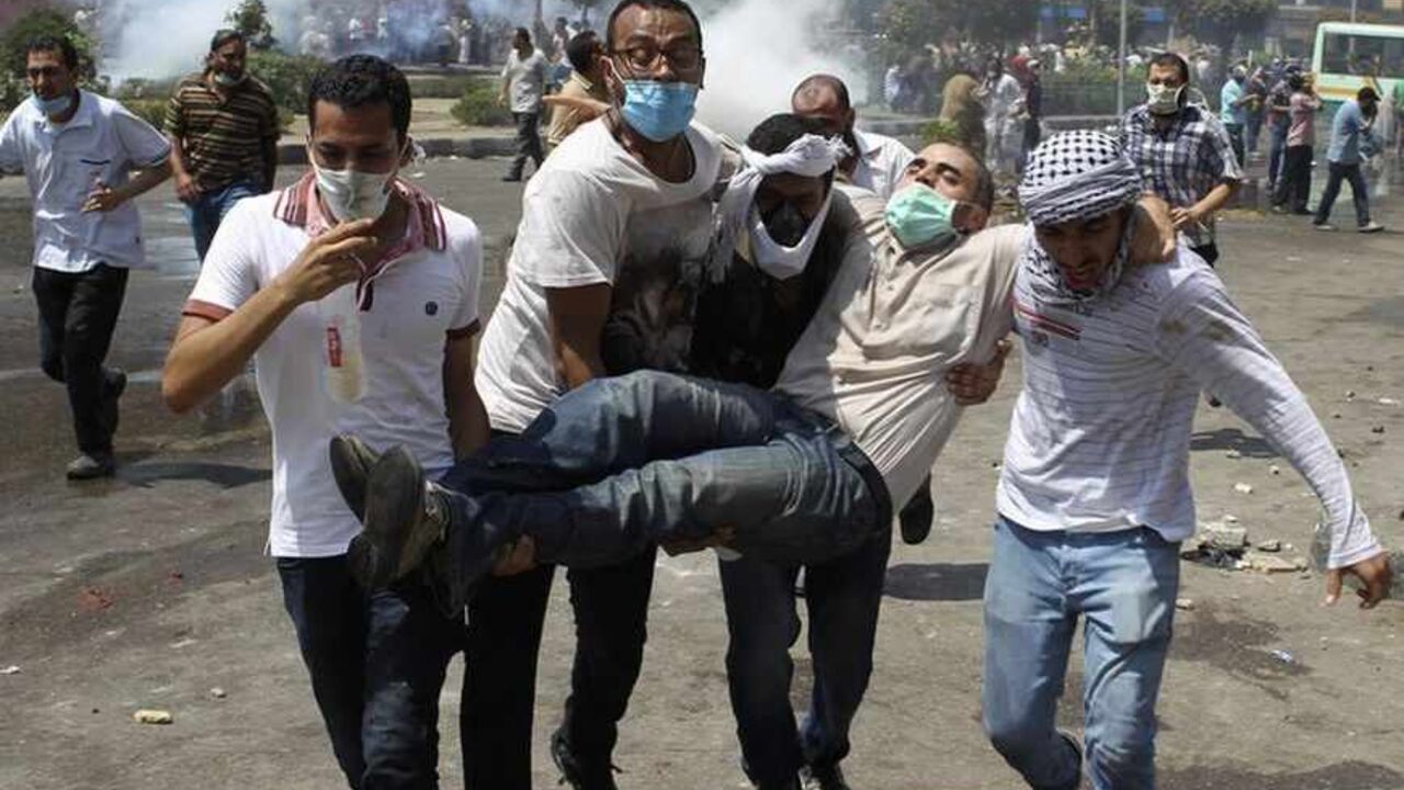Supporters of deposed Egyptian President Mohamed Mursi carry a protester injured during clashes with riot police and army at around the area of Rabaa Adawiya square, where they are camping, in Cairo ATTENTION EDITORS - VISUAL COVERAGE OF SCENES OF INJURY OR DEATH
Supporters of deposed Egyptian President Mohamed Mursi carry a protester injured during clashes with riot police and army at around the area of Rabaa Adawiya square, where they are camping, in Cairo August 14, 2013. The death toll from an Egyptian police raid on supporters of Mursi at a Cairo protest camp has climbed to 60 at one hospital, according to a nurse who said she counted the bodies. REUTERS/Asmaa Waguih (EGYPT - Tags: POLITICS CI