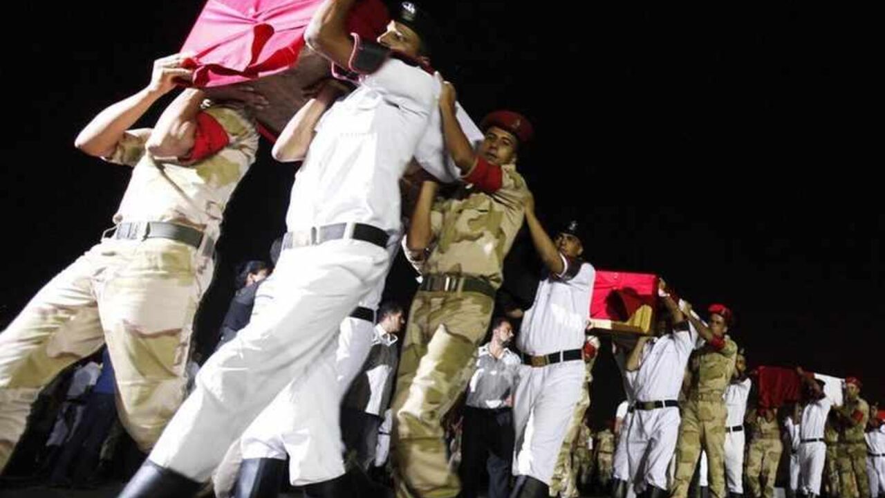 The caskets of 25 policemen killed early Monday morning near the north Sinai town of Rafah are carried after arriving at Almaza military airport in Cairo The caskets of 25 policemen killed early Monday morning near the north Sinai town of Rafah are carried after arriving at Almaza military airport in Cairo August 19, 2013. The 25 Egyptian policemen were killed and three others wounded in an ambush by Islamist militants, medical and security sources said. Attacks by Islamist militants in the lawless north Sinai region have intensified since the army overthrew Islamist President Mohamed Mursi on July 3. REUTERS/Mohamed Abd El Ghany (EGYPT - Tags: POLITICS CIVI