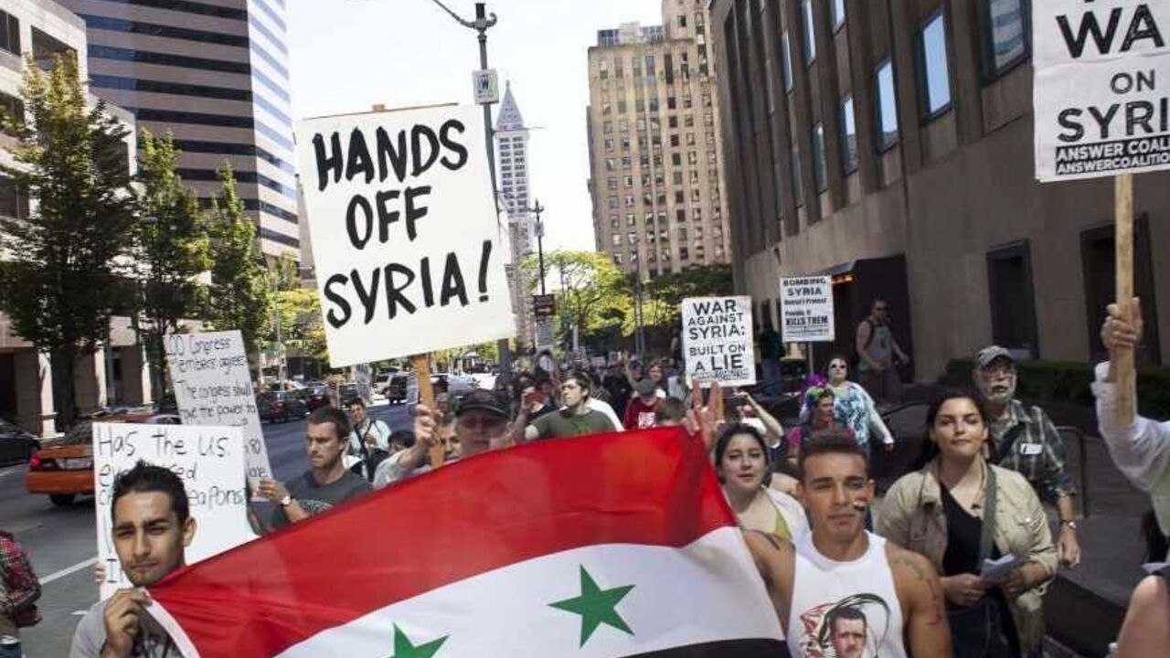 SYRIA-CRISIS/ Protesters, including Syrian-Americans Memo Nakour (L) and Wes Nakour (R), demonstrate against potential strikes on the Syrian government in Seattle, Washington August 31, 2013. REUTERS/David Ryder (UNITED STATES - Tags: POLITICS CIVIL UNREST) - RTX1333W