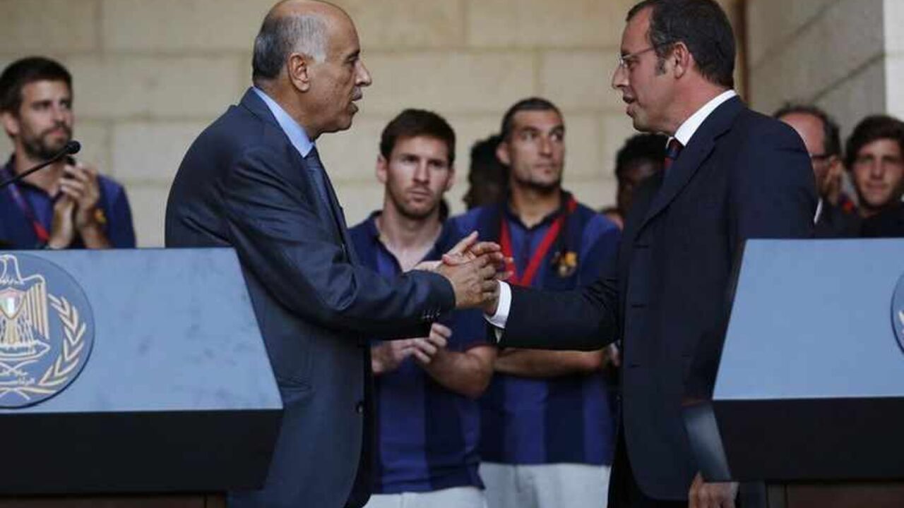 Barcelona President Sandro Rosell (R) and Palestinian Football Association President Jibril Rajoub shake hands after addressing members of the media at the start of a visit by the soccer team at the Palestinian President's office in the West Bank town of Bethlehem August 3, 2013. Barcelona is on a two-day "Peace Tour" in the region, which will include conducting soccer clinics for young people.
 REUTERS/Mohamad Torokman  (WEST BANK - Tags: SPORT SOCCER) - RTX129MC
