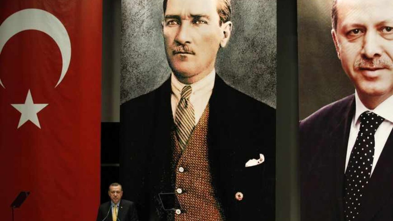 Turkey's Prime Minister Tayyip Erdogan addresses the members of his ruling AK Party in Ankara Turkey's Prime Minister Tayyip Erdogan addresses the members of his ruling AK Party (AKP), as he stands in front of the Turkey's national flag and portraits of Mustafa Kemal Ataturk, founder of modern Turkey, and of himself during a meeting at his party headquarters in Ankara July 11, 2012. REUTERS/Umit Bektas (TURKEY - Tags: POLITICS) - RTR34TO6