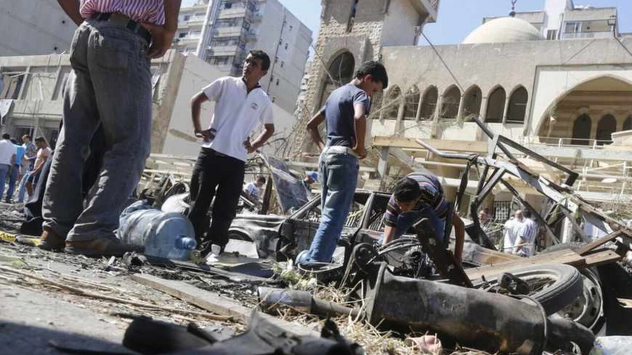 Relatives of car bomb victims inspect the damaged cars at the bomb explosion site in front of al-Salam mosque in the port city of Tripoli Relatives of car bomb victims inspect the damaged cars at the bomb explosion site in front of al-Salam mosque in the port city of Tripoli in northern Lebanon August 24, 2013. Bombs hit two mosques in the northern Lebanese city of Tripoli on Friday, killing at least 42 people and wounding hundreds, intensifying sectarian strife that has spilled over from the civil war in neighbouring Syria. REUTERS/Jamal Saidi (LEBANON - Tags: CIVIL UNREST POLITICS) - RTX12UWT