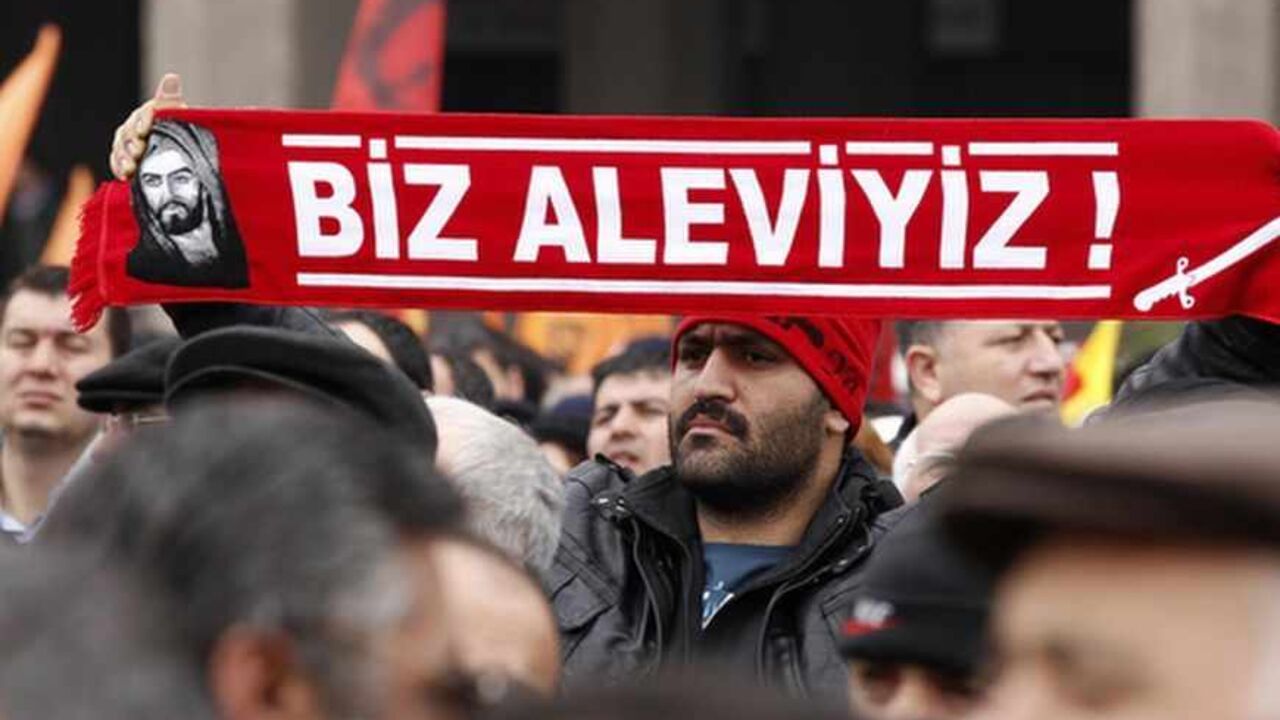 A protester holds a banner reading "we are alevi" as he and many others wait to hear the decision of the court in front of a courthouse in Ankara A protester holds a banner reading "we are alevi" as he and many others wait to hear the decision of the court in front of a courthouse in Ankara March 13, 2012. Turkish police fired tear-gas and water cannon to disperse hundreds protesting on Tuesday against the dropping of a case against five people charged with killing 37 writers and liberals in a 1993 hotel fire set off by Islamist rioters.The opposition accused Prime Minister Tayyip Erdogan and his AK Party, which emerged from a series of banned Islami