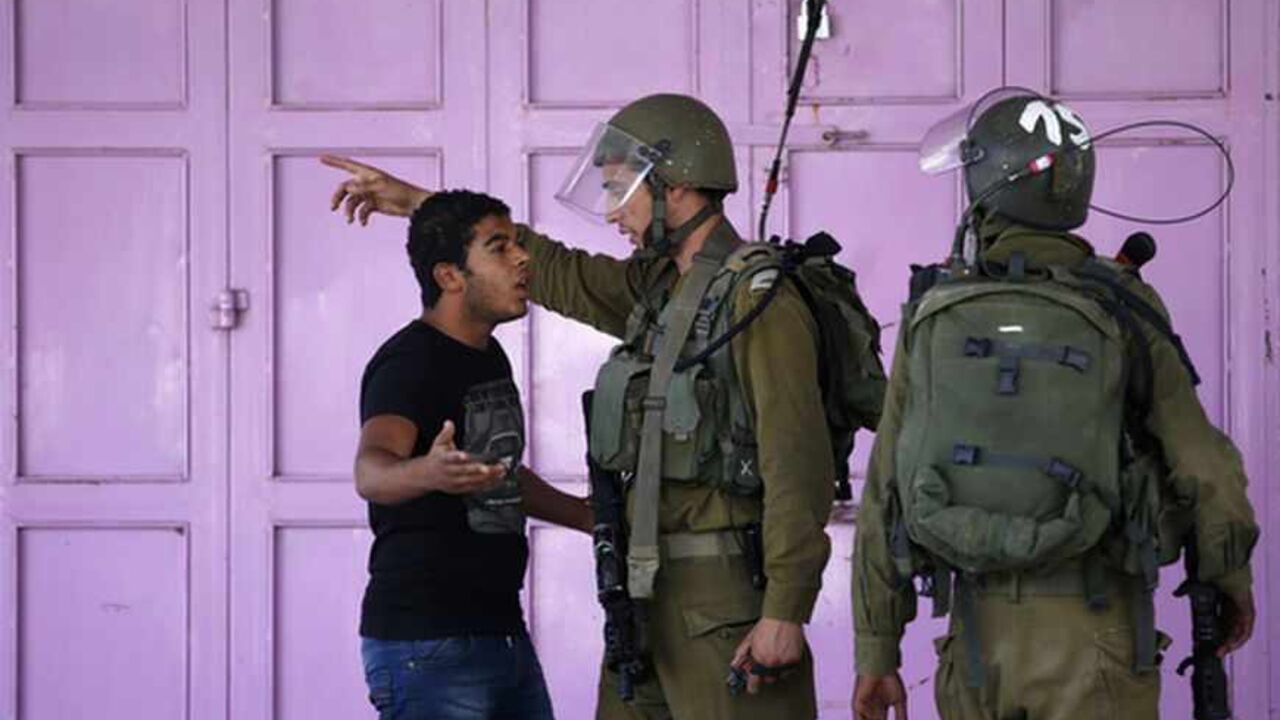 Palestinian argues with Israeli soldiers as he tries to walk through closed off area during clashes in Hebron A Palestinian argues with Israeli soldiers as he tries to walk through a closed off area during clashes in the West Bank city of Hebron September 23, 2013. An Israeli soldier was shot dead on Sunday during a Jewish festival in Hebron, a hotbed of tensions where some 500 Israeli settler families live among 100,000 Palestinians. He was the second Israeli serviceman killed since Friday by suspected Palestinian gunmen as tensions rise in the occupied territory despite a resumption of stalled U.S.-brokered peace