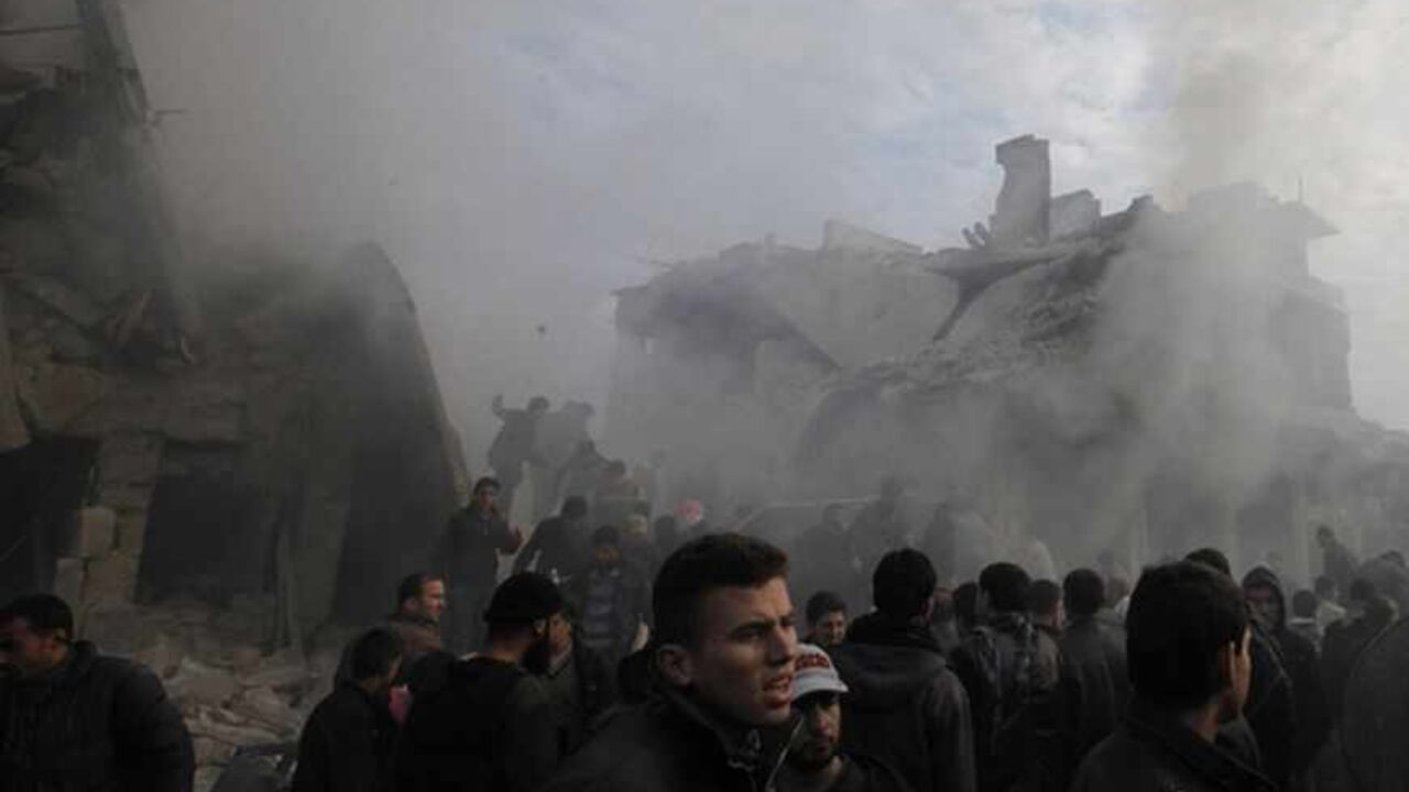 People gather at a site hit by what activists said was missiles fired by a Syrian Air Force fighter jet from forces loyal to Syria's President Bashar al-Assad, at the souk of Azaz People gather at a site hit by what activists said was missiles fired by a Syrian Air Force fighter jet from forces loyal to Syria's President Bashar al-Assad, at the souk of Azaz, north of Aleppo, January 13, 2013. REUTERS/Zain Karam (SYRIA - Tags: CONFLICT TPX IMAGES OF THE DAY) - RTR3CEBT