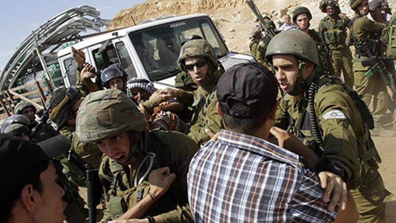 PALESTINIANS-ISRAEL/EU-HAMLET Israeli soldiers scuffle with Palestinians near a truck loaded with items European diplomats wanted to deliver to locals in the West Bank herding community of Khirbet al-Makhul, in the Jordan Valley September 20, 2013. Israeli soldiers manhandled European diplomats on Friday and seized a truck full of tents and emergency aid they had been trying to deliver to Palestinians whose homes were demolished earlier this week. REUTERS/Abed Omar Qusini (WEST BANK - Tags: POLITICS CIVIL UNREST MILITARY) - RTX13SGZ
