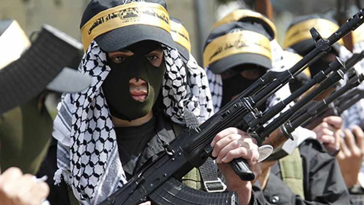 LEBANON/ Palestinian Fatah members carry their weapons as they take part in a parade to mark the 65th anniversary of Nakba, at Ain al-Hilweh Palestinian refugee camp near the port-city of Sidon, southern Lebanon May 15, 2013. Palestinians marked "Nakba" (Catastrophe) to commemorate the expulsion or fleeing of hundreds of thousands of their brethren from their homes in the war that led to the founding of Israel in 1948. REUTERS/Ali Hashisho (LEBANON - Tags: POLITICS ANNIVERSARY) - RTXZN6R