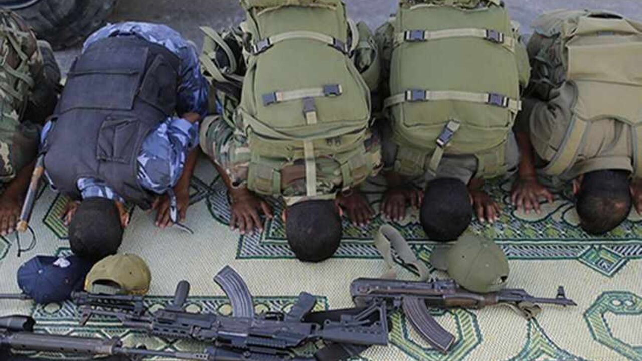 Members of Hamas security forces pray before a rally calling on Egyptian authorities to open the Rafah border crossing, at the crossing in the southern Gaza Strip September 17, 2013. Cairo closed the Rafah crossing, Gaza's main window to the world, completely last week after assailants crashed two explosive-laden cars into a security building adjacent to the border zone, killing six Egyptian soldiers. Ashraf al-Qidra, spokesman for the Hamas-run Gaza Health Ministry, said 1,000 patients a month required med